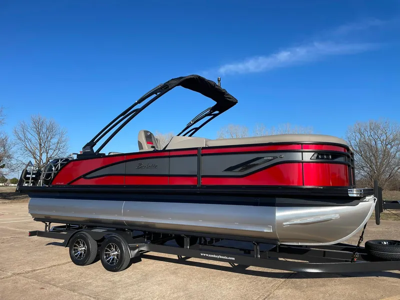 Slide: The Image of 2024 Barletta CORSA 23UCA pontoon boat with red and black exterior on trailer. - 14