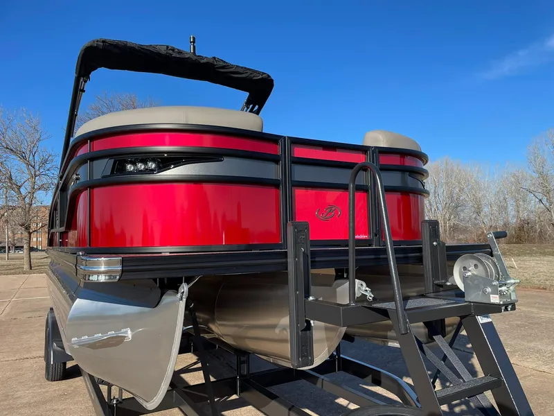 Slide: The Image of 2024 Barletta CORSA 23UCA pontoon boat with red exterior and black canopy. - 16