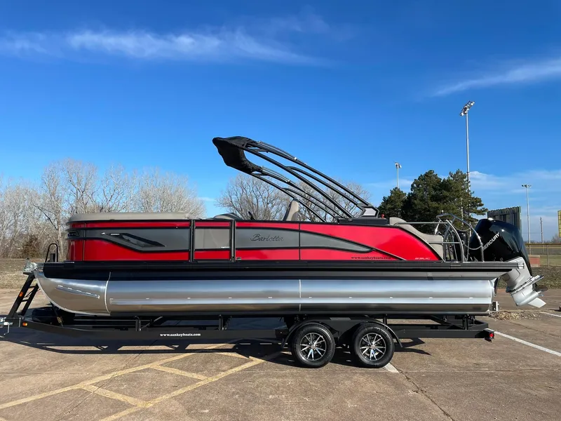 Slide: The Image of 2024 Barletta CORSA 23UCA pontoon boat in red and black on a trailer. - 2