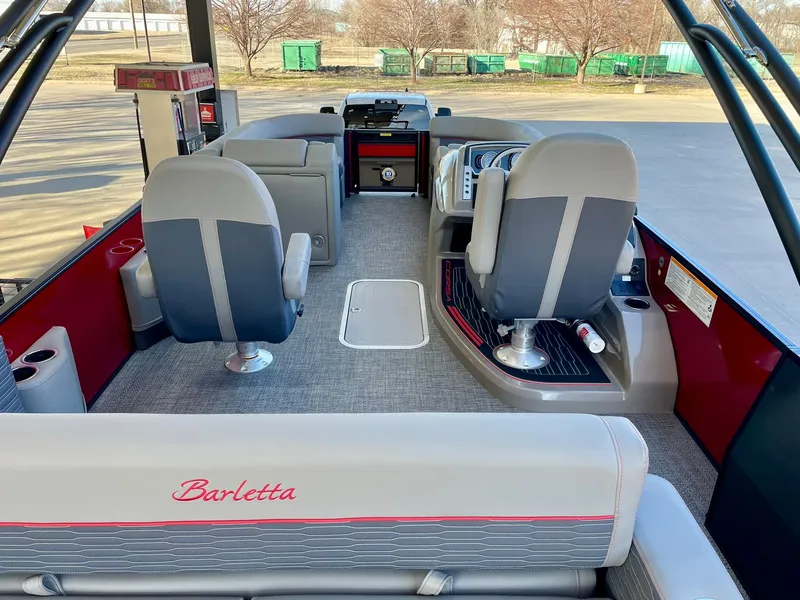 Slide: The Image of 2024 Barletta CORSA 23UCA boat interior with modern seating and dashboard. - 23