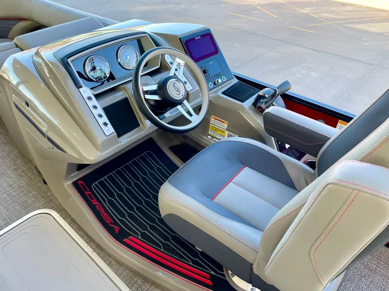 Slide: The Image of 2024 Barletta CORSA 23UCA boat cockpit with steering wheel and control panel. - 26