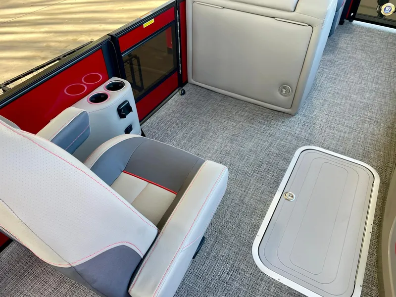 Slide: The Image of 2024 Barletta CORSA 23UCA interior with gray seating, red accents, and carpeted flooring. - 27