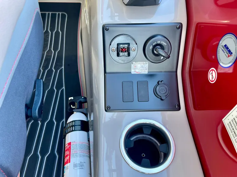 Slide: The Image of Control panel of 2024 Barletta CORSA 23UCA with ignition switch, cup holder, and fire extinguisher. - 42