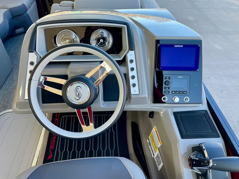 Slide: The Image of 2024 Barletta CORSA 23UCA boat dashboard with steering wheel and navigation system. - 43