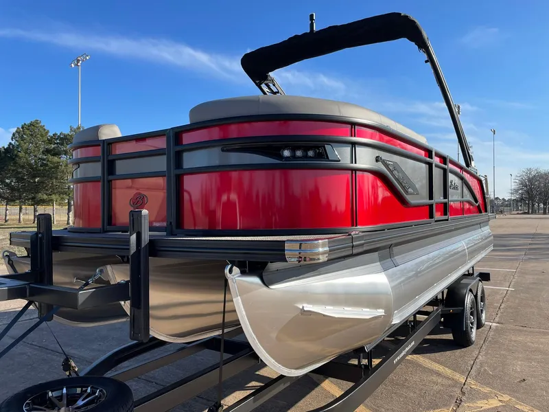 Slide: The Image of 2024 Barletta CORSA 23UCA pontoon boat with red exterior on a trailer. - 5