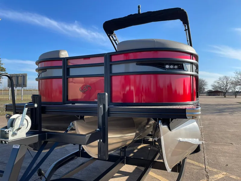 Slide: The Image of 2024 Barletta CORSA 23UCA pontoon boat with red exterior on a trailer. - 6