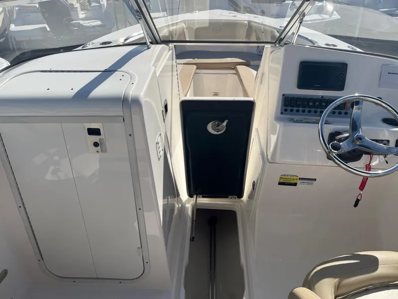 Slide: The Image of 2020 Key West 239 DFS boat interior with steering wheel and control panel. - 10