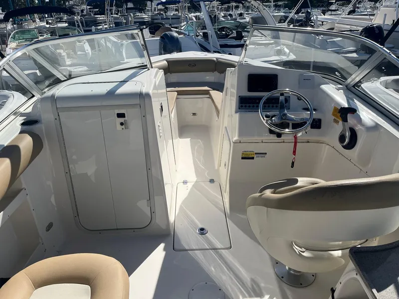 Slide: The Image of 2020 Key West 239 DFS boat interior with helm and seating area. - 2