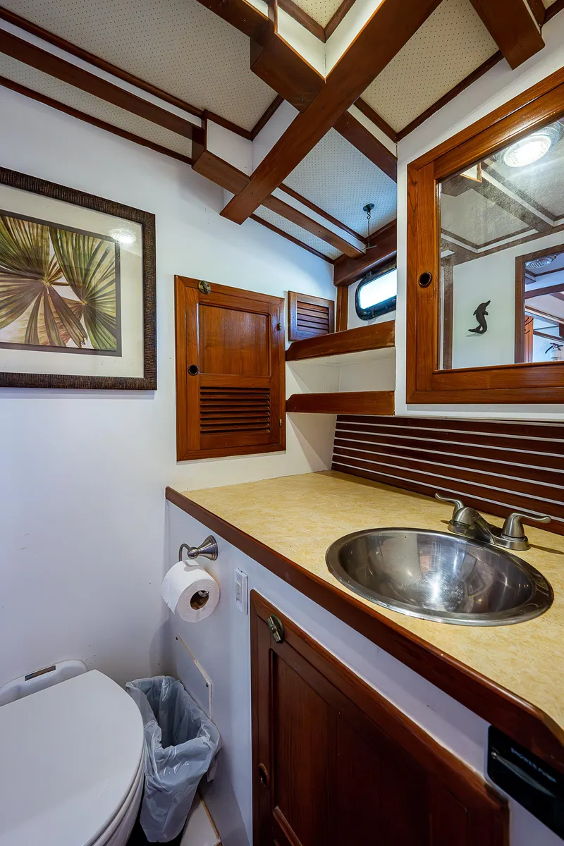 Slide: The Image of 1983 Krogen 42 yacht bathroom with wooden cabinetry and stainless steel sink. - 10