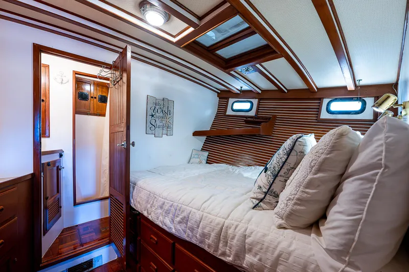 Slide: The Image of Cozy cabin interior of 1983 Krogen 42 yacht with wood paneling and skylights. - 11