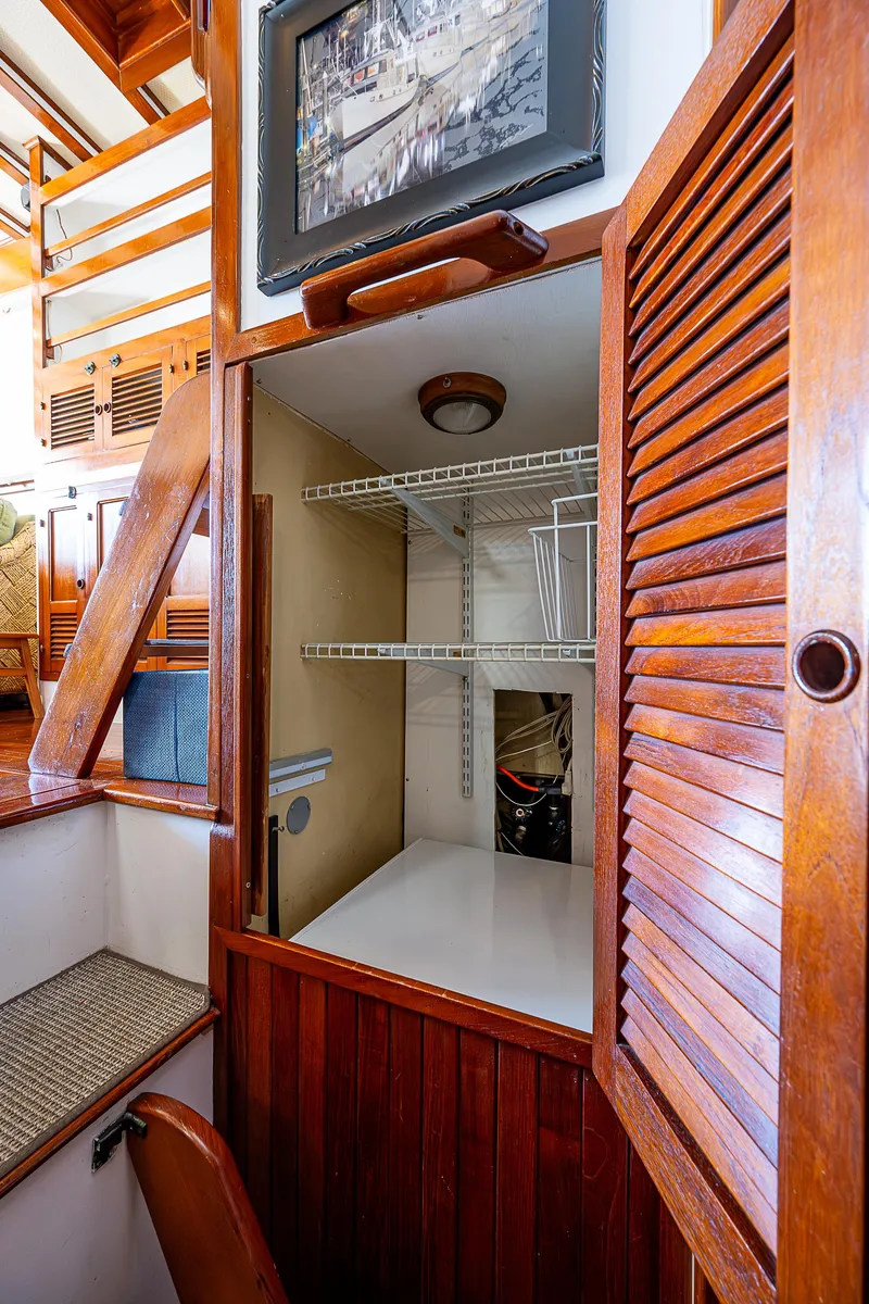 Slide: The Image of Interior of 1983 Krogen 42 boat with wooden cabinetry and shelving. - 22