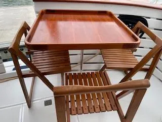 Slide: The Image of Wooden folding table and chairs on a 1983 Krogen 42 boat deck. - 23