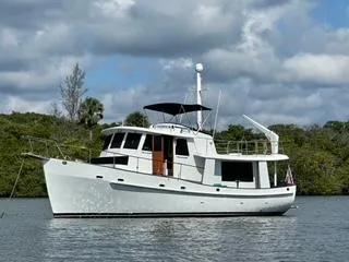 Slide: The Image of 1983 Krogen 42 yacht on calm water with cloudy sky background. - 25