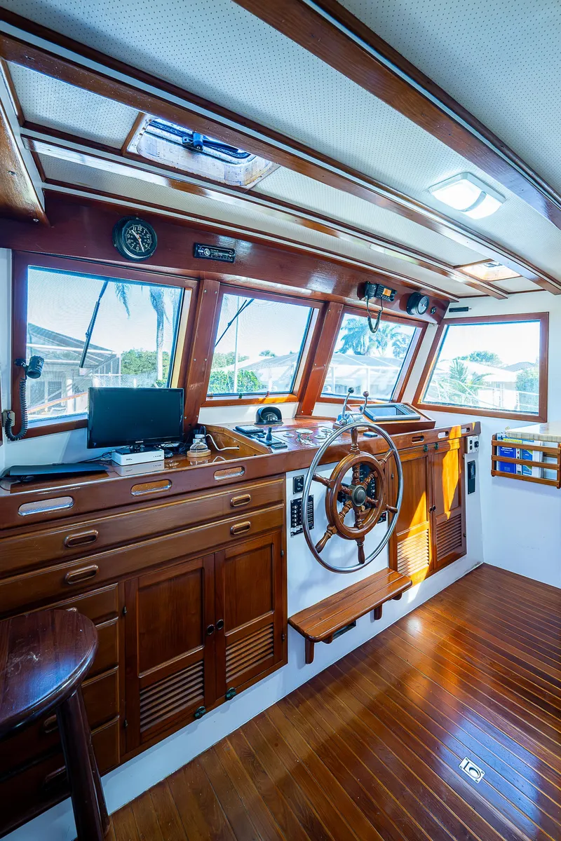 Slide: The Image of 1983 Krogen 42 yacht interior with wooden helm and navigation equipment. - 37