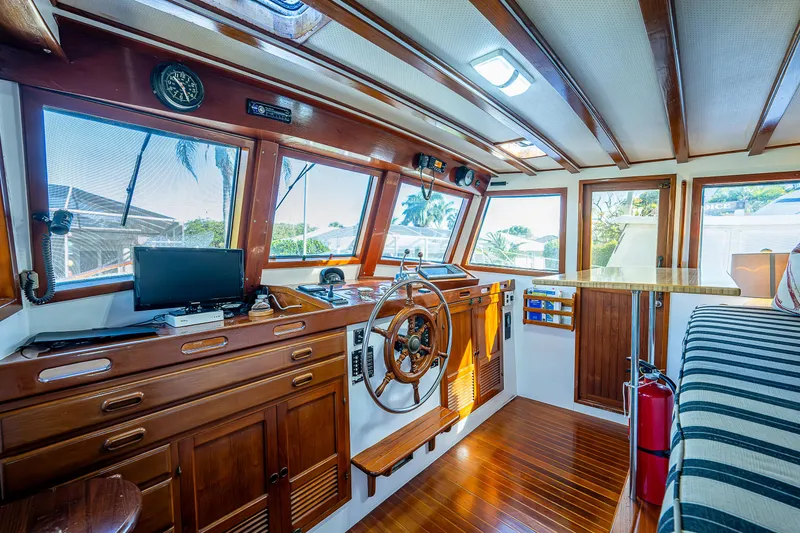 Slide: The Image of Interior of 1983 Krogen 42 boat with wooden helm, seating, and navigation equipment. - 38