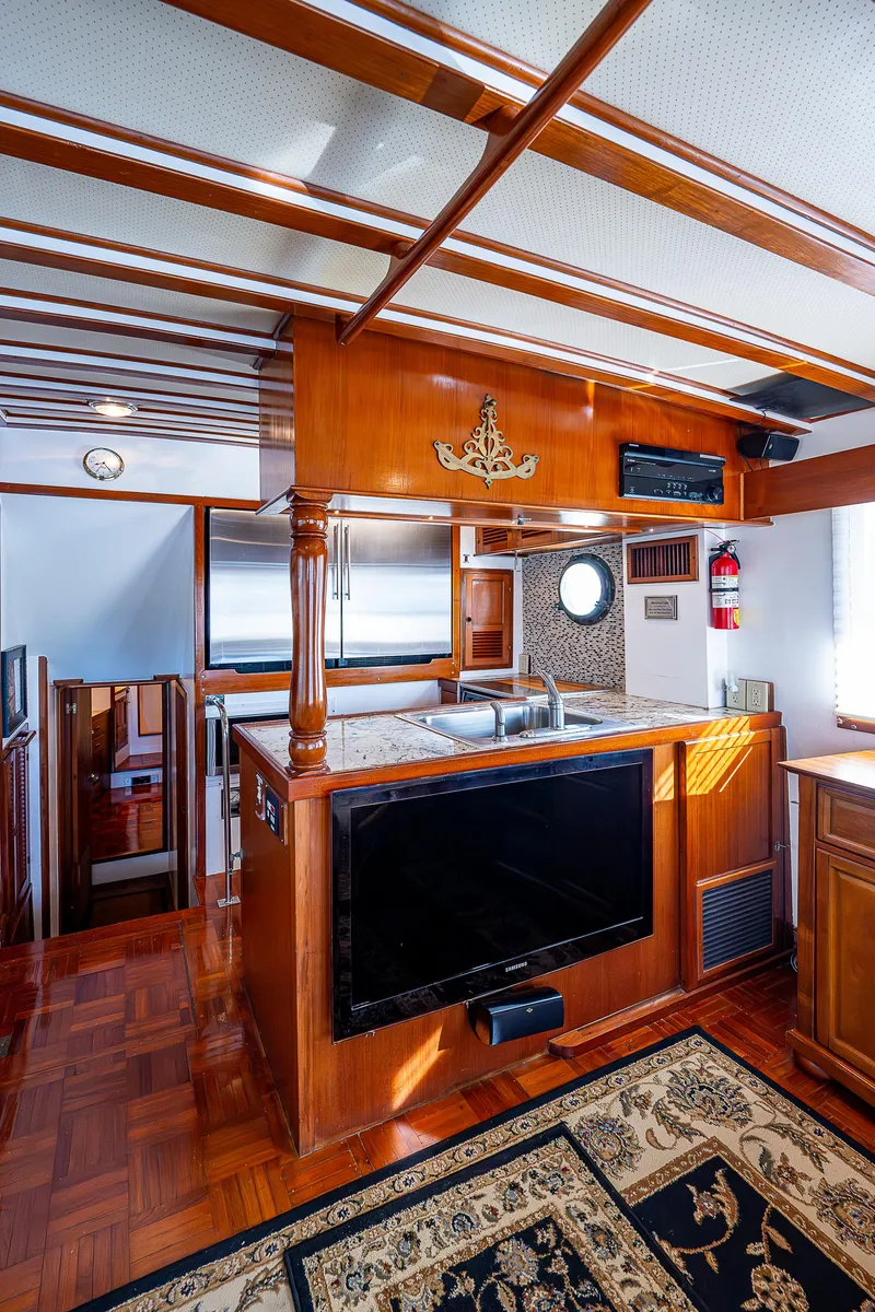 Slide: The Image of 1983 Krogen 42 yacht interior with wood finish, TV, and nautical decor. - 5