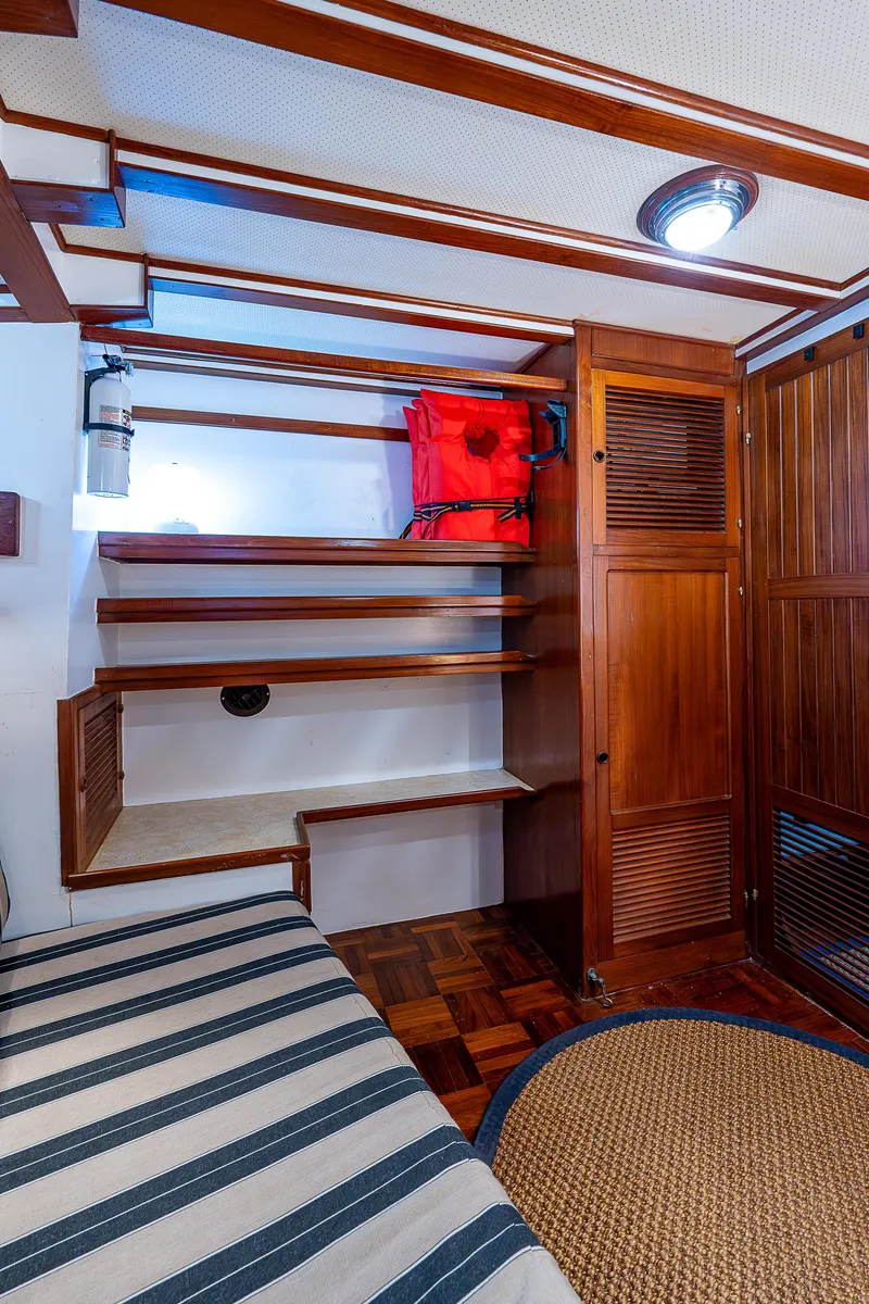 Slide: The Image of Interior of 1983 Krogen 42 yacht with wooden stairs and striped seating. - 8