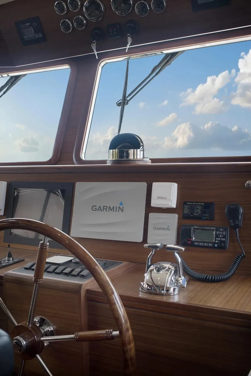 Slide: The Image of Helm of 2026 Selene 72 Classic Explorer with Garmin navigation, wooden wheel, and clear sky view. - 12