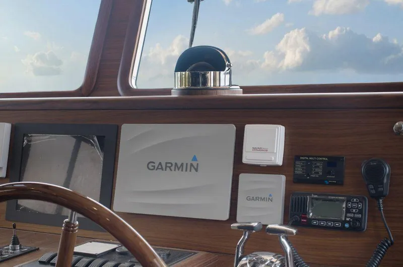 Slide: The Image of Selene 72 Classic Explorer 2026 helm with Garmin navigation equipment and wooden dashboard. - 16