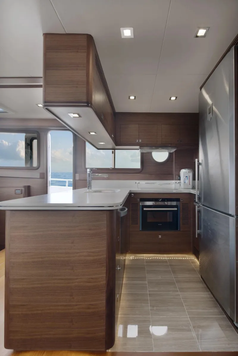 Slide: The Image of Modern kitchen interior of 2026 Selene 72 Classic Explorer yacht, featuring sleek wood cabinetry and stainless steel appliances. - 9