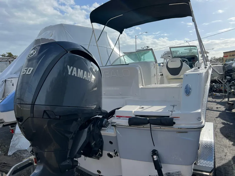 Slide: The Image of 2024 Robalo R207 Dual Console boat with Yamaha 150 engine, rear view. - 2