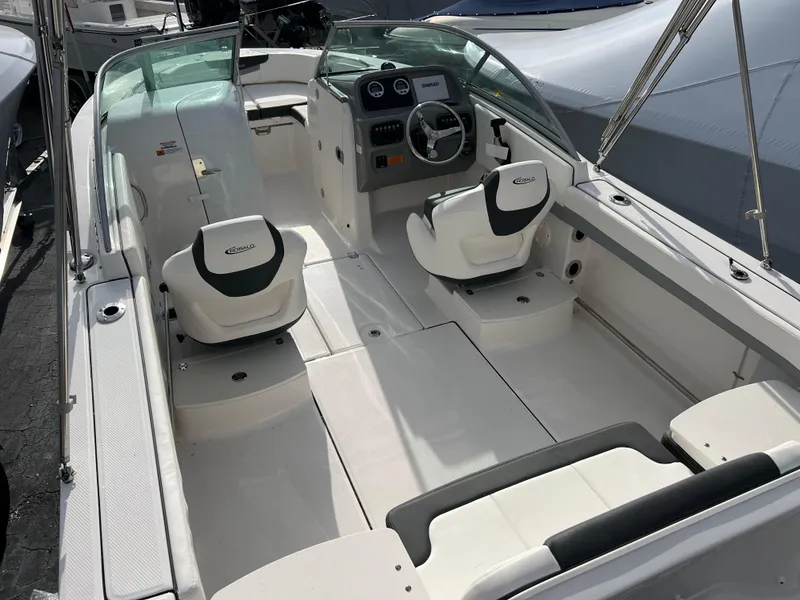 Slide: The Image of 2024 Robalo R207 Dual Console boat interior with seating and steering console. - 3