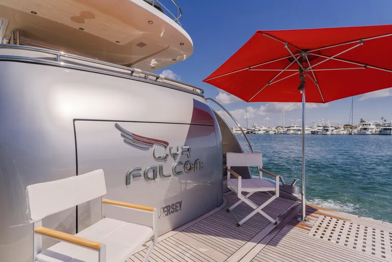 Slide: The Image of Van der Valk 78 Flybridge Motor Yacht 2016, docked with chairs and red umbrella. - 13