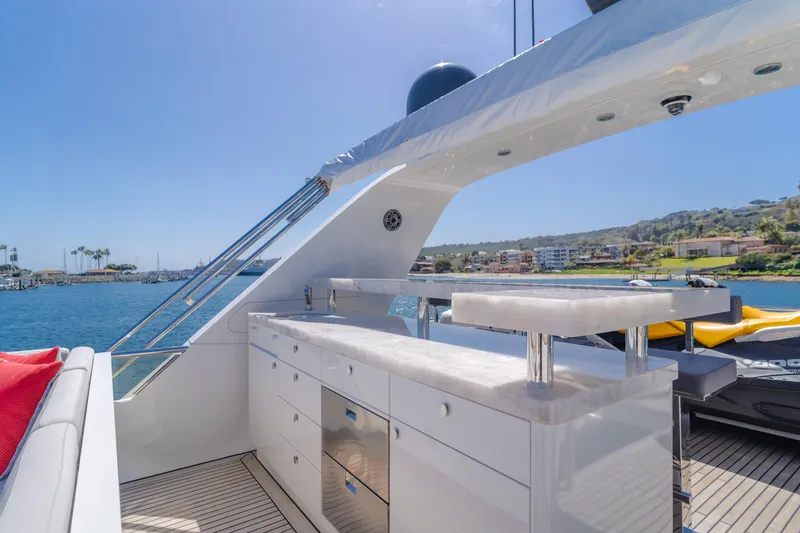 Slide: The Image of Flybridge of 2016 Van der Valk 78 Motor Yacht with outdoor kitchen and scenic harbor view. - 27