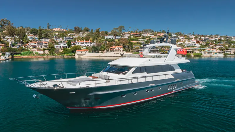 Slide: The Image of Van der Valk 78 Flybridge Motor Yacht 2016 cruising near coastal homes. - 3