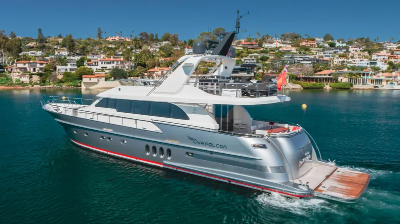 Slide: The Image of 2016 Van der Valk 78 Flybridge Motor Yacht cruising near coastal homes. - 5