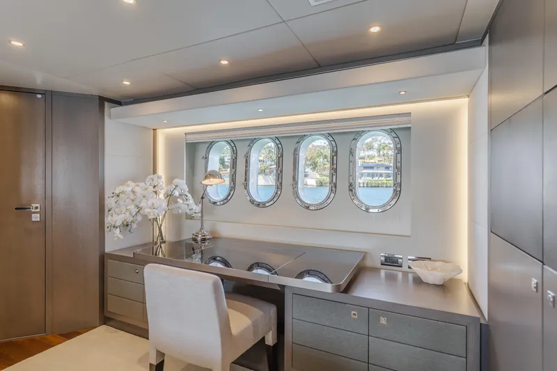 Slide: The Image of Luxurious interior of 2016 Van der Valk 78 Flybridge Motor Yacht with elegant desk and porthole windows. - 51