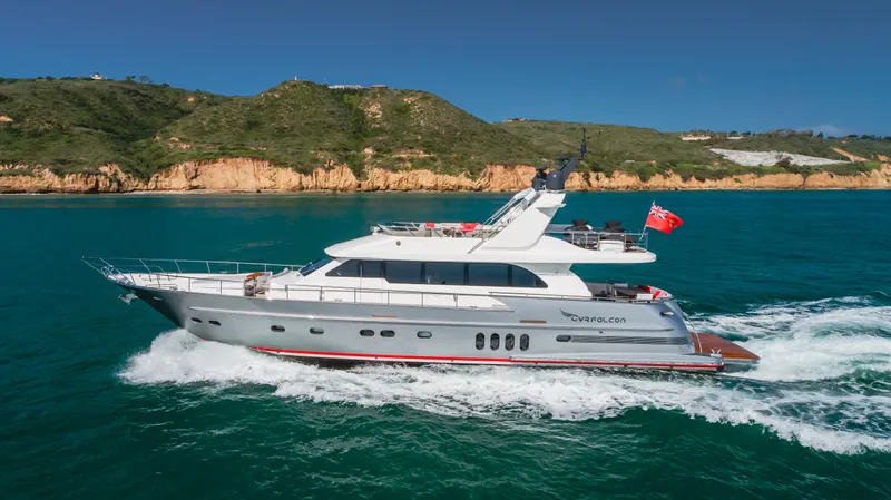 Slide: The Image of 2016 Van der Valk 78 Flybridge Motor Yacht cruising near a scenic coastline. - 6