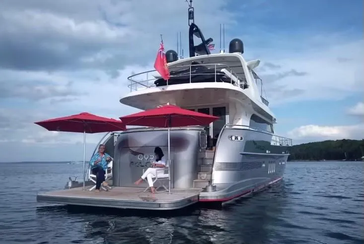 Slide: The Image of Van der Valk 78 Flybridge Motor Yacht 2016 on water with red umbrellas and seated passengers. - 9