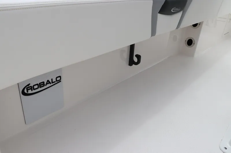 Slide: The Image of 2024 Robalo 266 Cayman boat interior detail with logo and storage hooks. - 10