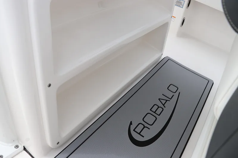 Slide: The Image of 2024 Robalo 266 Cayman boat interior with branded floor mat. - 13