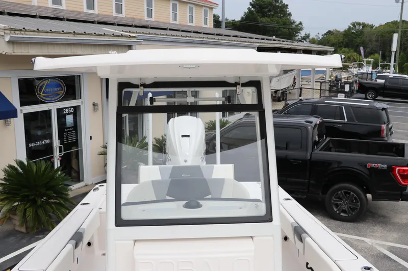 Slide: The Image of 2024 Robalo 266 Cayman boat displayed at a dealership. - 21