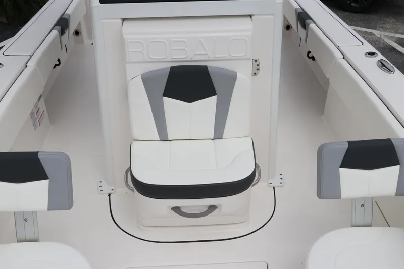 Slide: The Image of 2024 Robalo 266 Cayman boat seating area with stylish white and gray upholstery. - 22