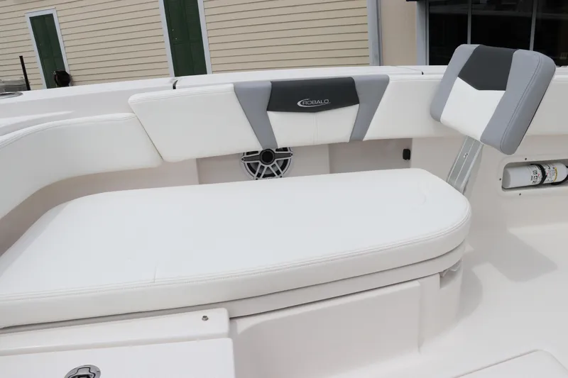 Slide: The Image of 2024 Robalo 266 Cayman boat interior with white cushioned seating. - 25