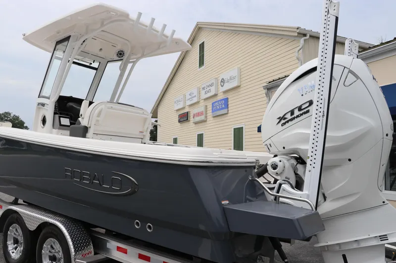 Slide: The Image of 2024 Robalo 266 Cayman boat on trailer with powerful outboard motor. - 4