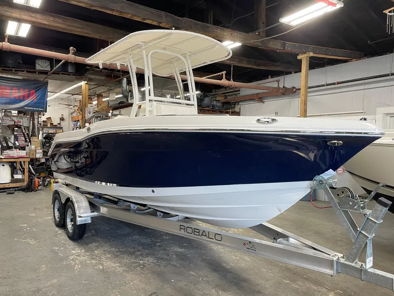 Slide: The Image of 2024 Robalo R200 Center Console boat on a trailer in a warehouse. - 0
