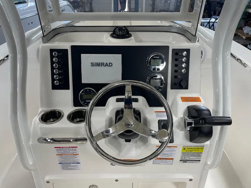 Slide: The Image of 2024 Robalo R200 Center Console boat dashboard with Simrad electronics. - 10