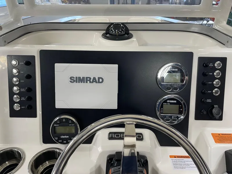 Slide: The Image of 2024 Robalo R200 Center Console dashboard with Simrad electronics and Yamaha gauges. - 11