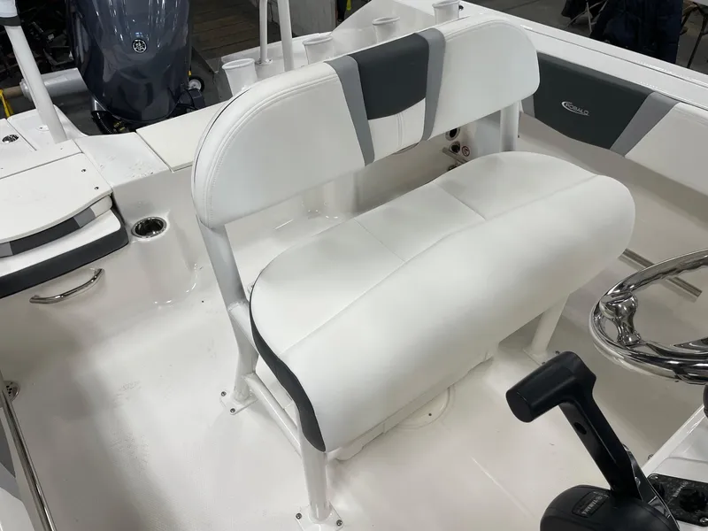 Slide: The Image of 2024 Robalo R200 Center Console boat interior with white cushioned seating. - 13