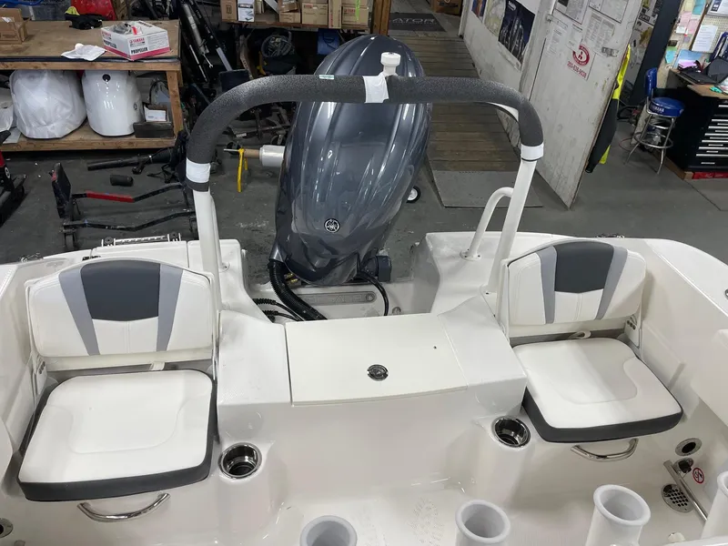 Slide: The Image of 2024 Robalo R200 Center Console boat interior with seating and outboard motor. - 14