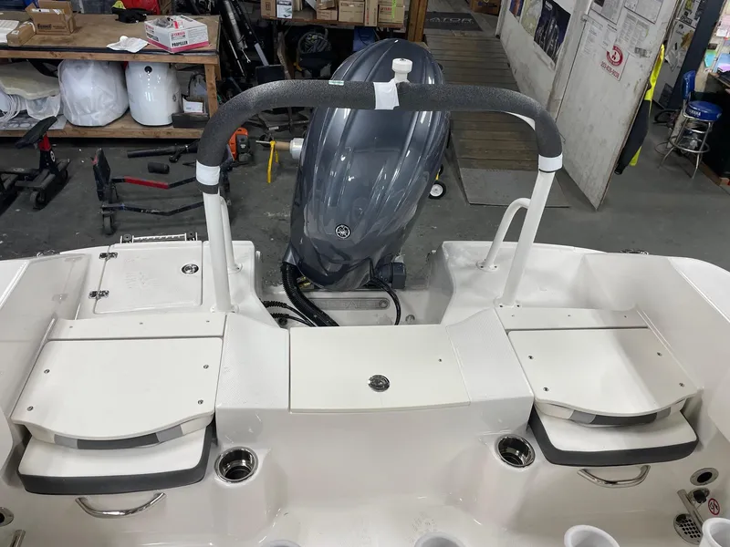 Slide: The Image of 2024 Robalo R200 Center Console boat with Yamaha outboard motor in a workshop. - 15