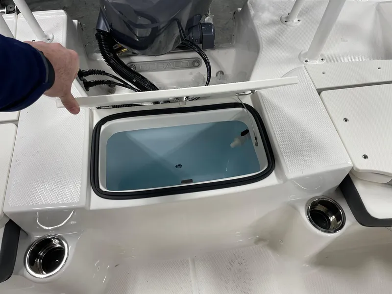 Slide: The Image of 2024 Robalo R200 Center Console livewell compartment with open lid. - 16