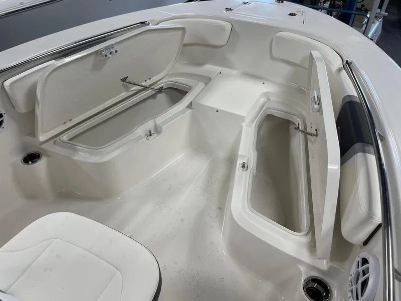 Slide: The Image of 2024 Robalo R200 Center Console boat with open storage compartments. - 18