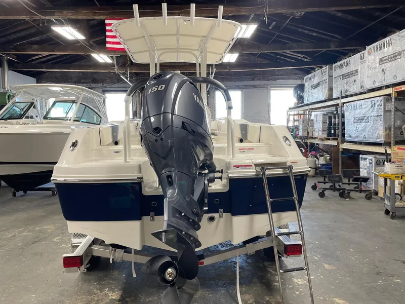 Slide: The Image of 2024 Robalo R200 Center Console boat with Yamaha 150 engine in a warehouse. - 5