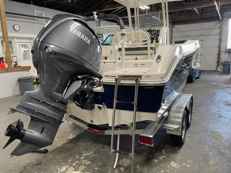 Slide: The Image of 2024 Robalo R200 Center Console boat with Yamaha outboard motor in a garage. - 6