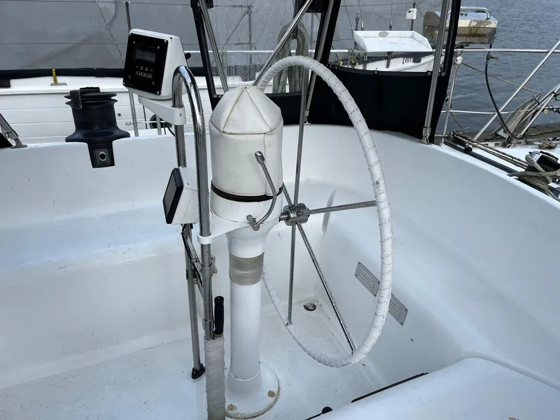 Slide: The Image of 1985 Barnett Offshore sailboat helm with steering wheel and navigation instruments. - 12